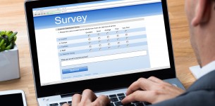 Businessman Giving Online Survey On Laptop